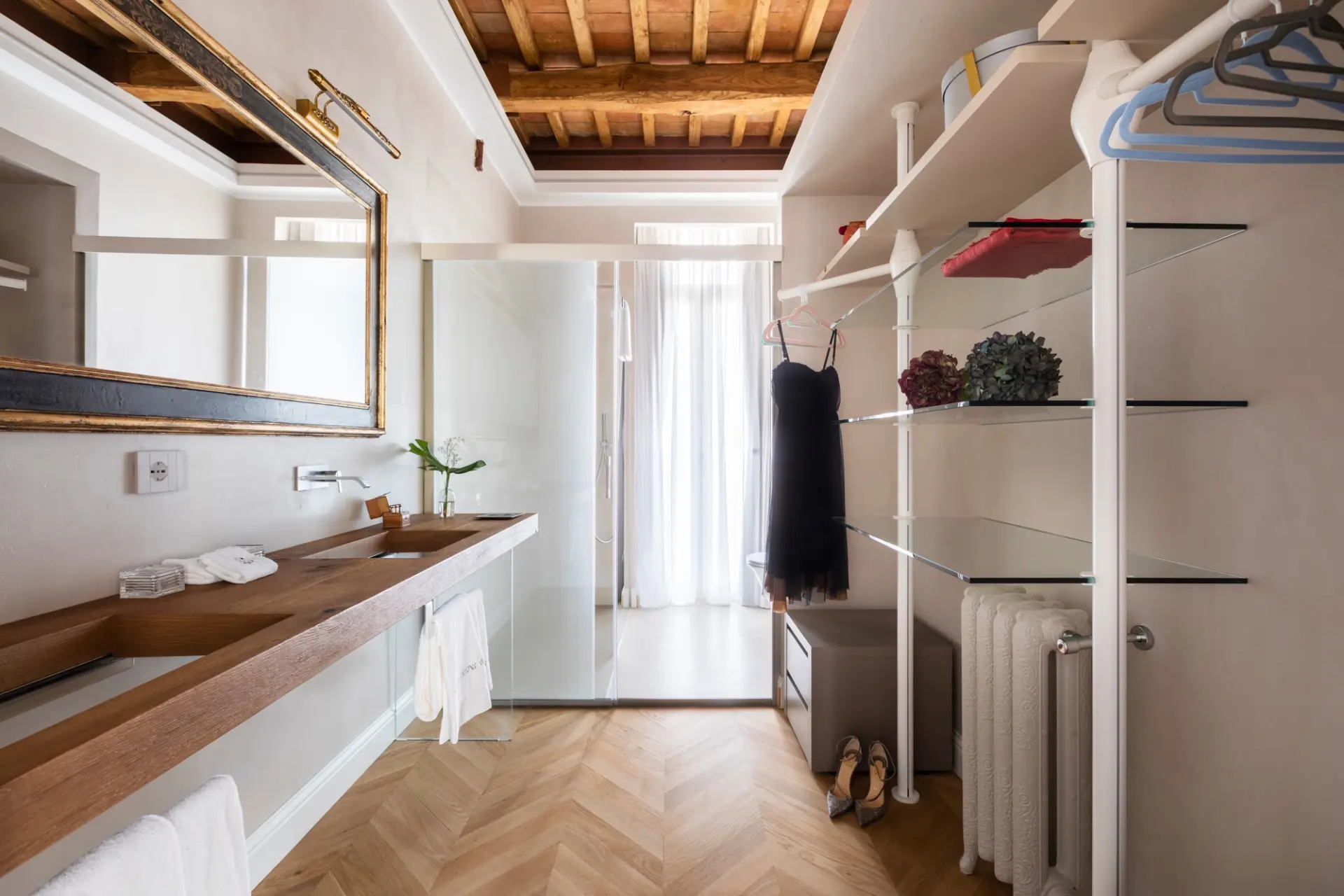 Dettaglio zona living della suite Angolo relax con poltroncina e comodino sospeso